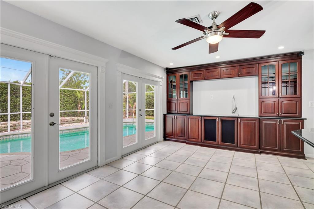 3035 42nd Terrace Southwest Naples, FL 34116 - Photo 34 of 48 Unfurnished living room featuring french doors, ceiling fan, light tile patterned floors, and recessed lighting