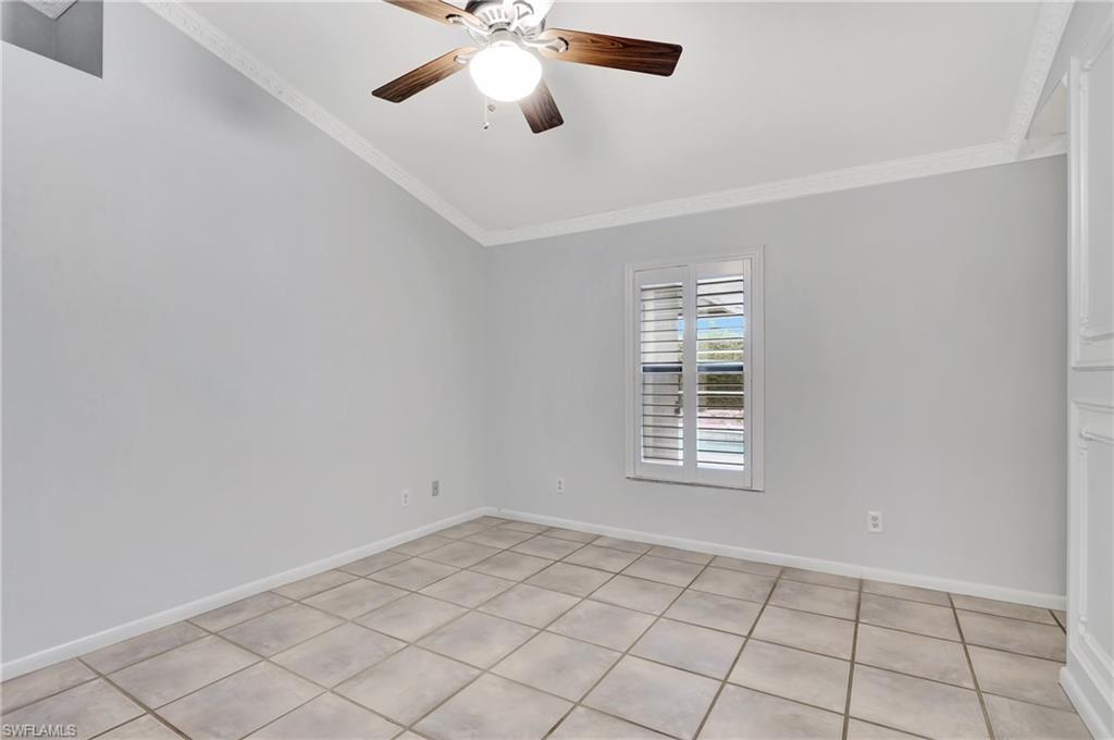 3035 42nd Terrace Southwest Naples, FL 34116 - Photo 36 of 48 Master bedroom featuring a ceiling fan, crown molding, and light tile patterned floors.