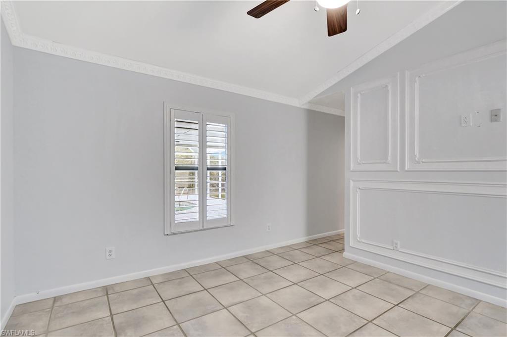 3035 42nd Terrace Southwest Naples, FL 34116 - Photo 39 of 48 Master bedroom with ceiling fan, lofted ceiling, crown molding, and light tile patterned floors