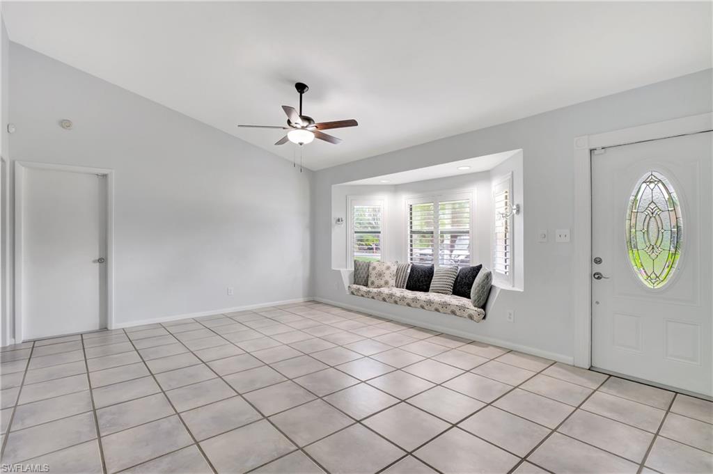 3035 42nd Terrace Southwest Naples, FL 34116 - Photo 9 of 48 Entrance foyer with lofted ceiling, a ceiling fan, and light tile patterned flooring