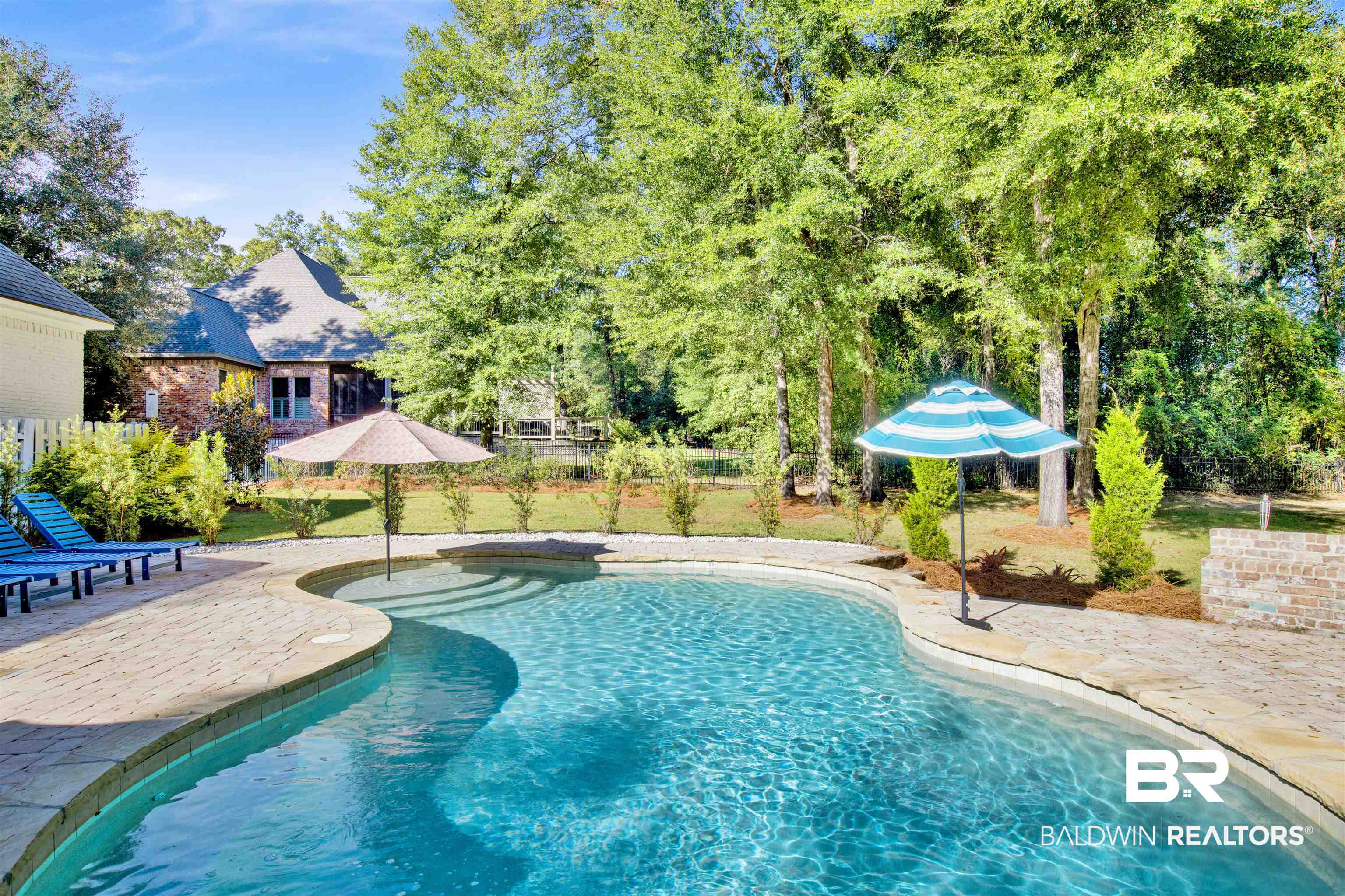 11116 Redfern Road Daphne, AL 36526 - Photo 14 of 46 Outdoor pool with a patio and view of scattered trees