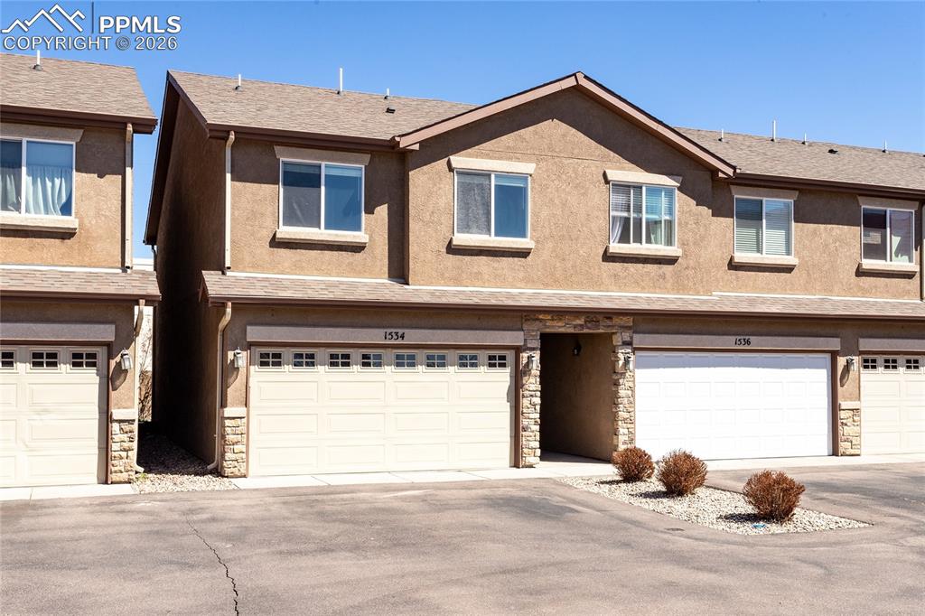 a front view of a house with a garage and a window
