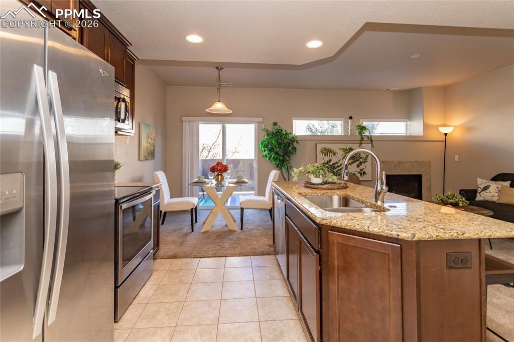 1534 York Road Colorado Springs, CO 80920 - Photo 11 of 38 a kitchen with stainless steel appliances granite countertop a sink a stove and a refrigerator