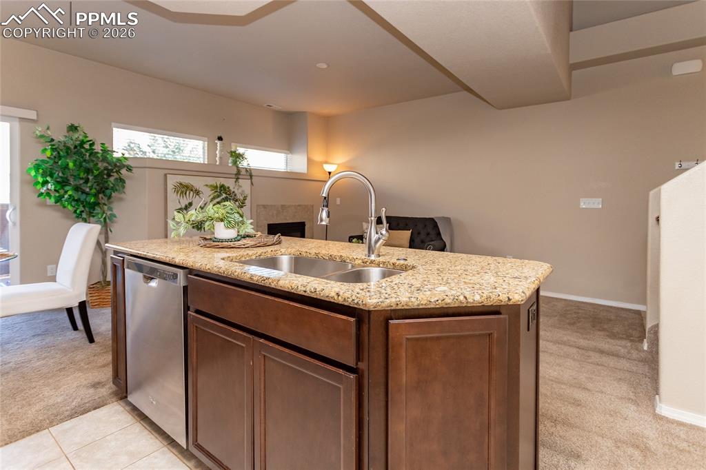 1534 York Road Colorado Springs, CO 80920 - Photo 12 of 38 a kitchen with granite countertop kitchen island stainless steel appliances a sink table and chairs