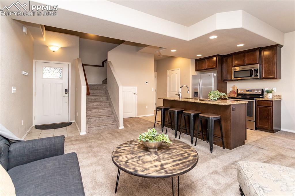 1534 York Road Colorado Springs, CO 80920 - Photo 13 of 38 a kitchen with a stove a sink a table and chairs