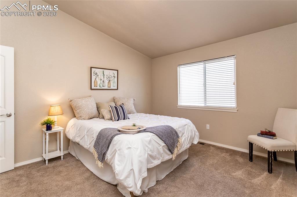 1534 York Road Colorado Springs, CO 80920 - Photo 25 of 38 a bedroom with a bed and a chair