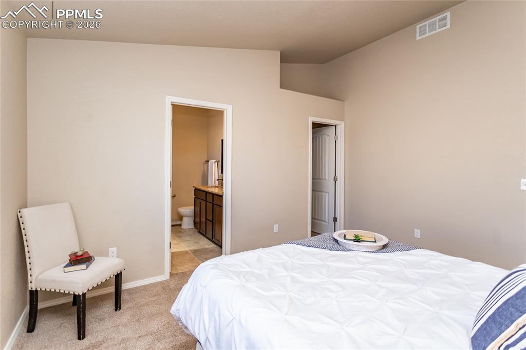 1534 York Road Colorado Springs, CO 80920 - Photo 27 of 38 a bedroom with a bed and a chair