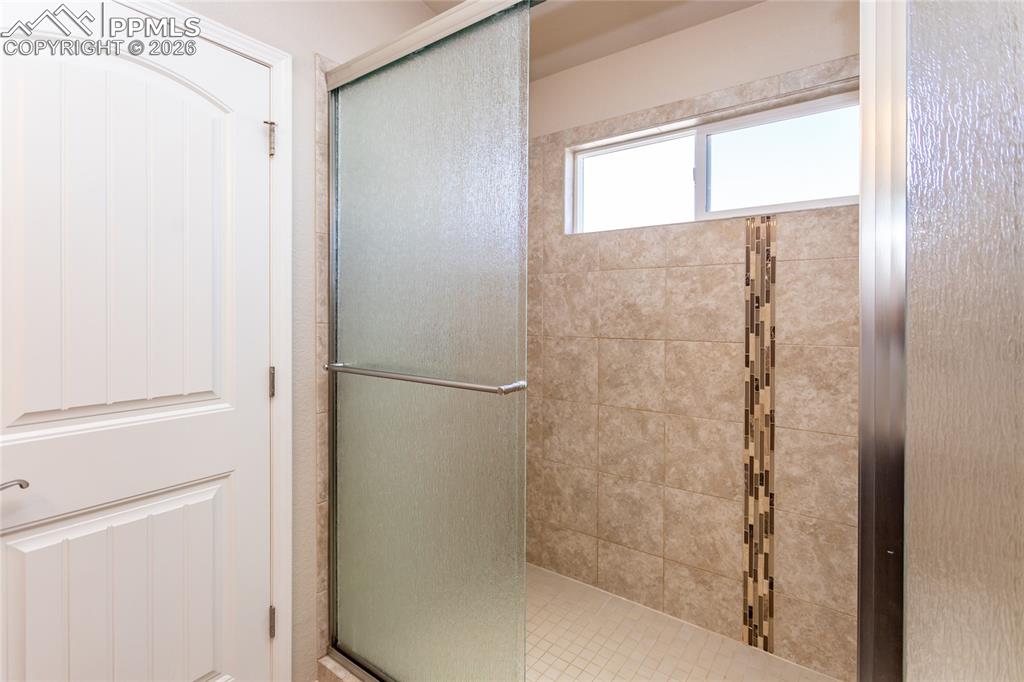 1534 York Road Colorado Springs, CO 80920 - Photo 30 of 38 a bathroom with a glass shower door