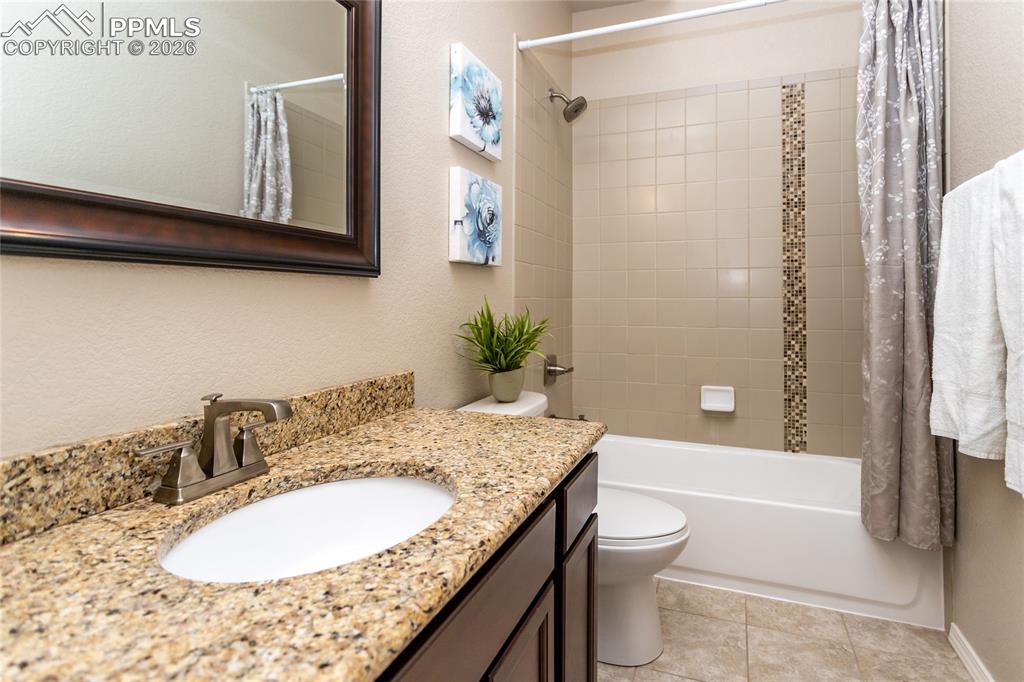 1534 York Road Colorado Springs, CO 80920 - Photo 32 of 38 a bathroom with a granite countertop sink toilet and shower