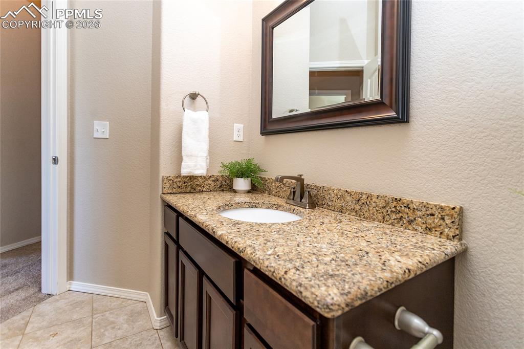 1534 York Road Colorado Springs, CO 80920 - Photo 33 of 38 a bathroom with a granite countertop sink and a mirror
