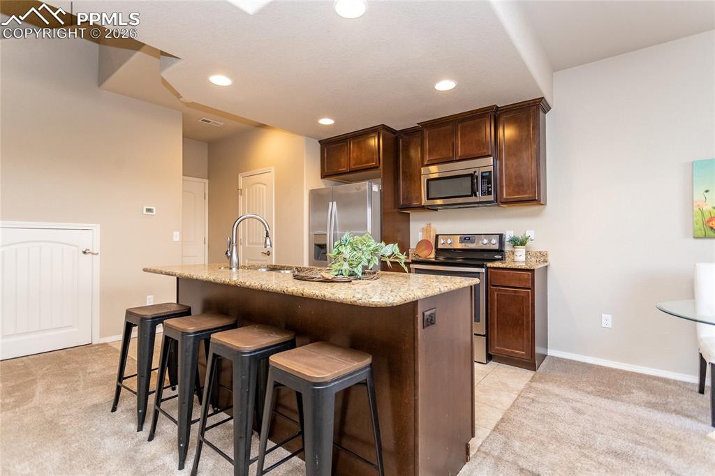 1534 York Road Colorado Springs, CO 80920 - Photo 7 of 38 a kitchen with stainless steel appliances granite countertop a sink and cabinets