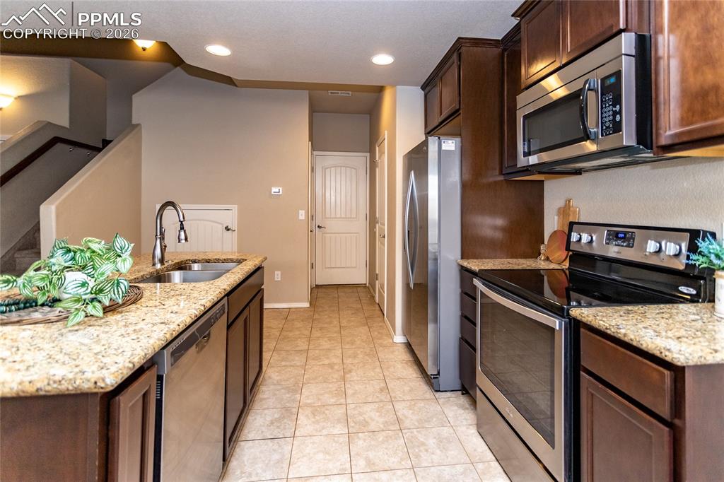 1534 York Road Colorado Springs, CO 80920 - Photo 8 of 38 a kitchen with stainless steel appliances granite countertop a stove a sink and a microwave