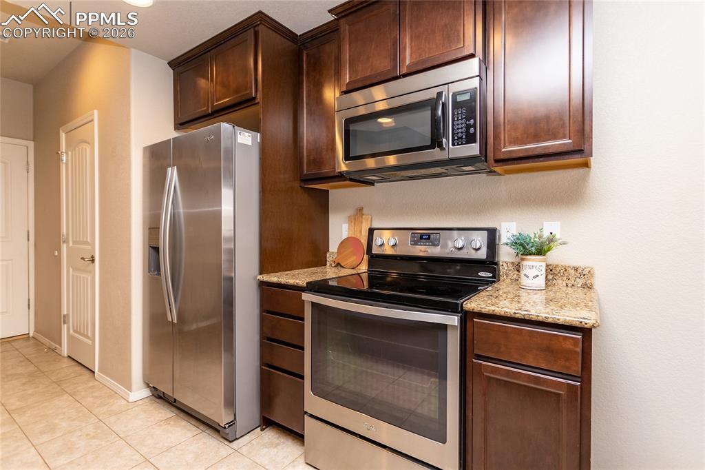 1534 York Road Colorado Springs, CO 80920 - Photo 9 of 38 a kitchen with stainless steel appliances granite countertop a refrigerator stove and microwave