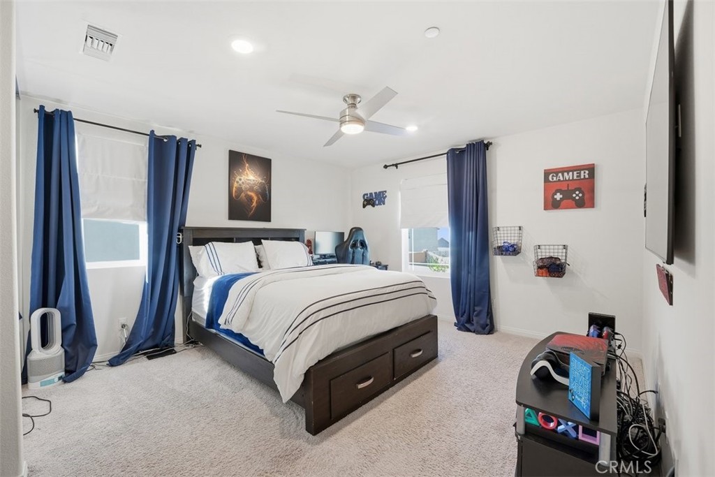 7608 Citrusmoon Court Riverside, CA 92507 - Photo 17 of 25 a spacious bedroom with a bed and a walk in closet