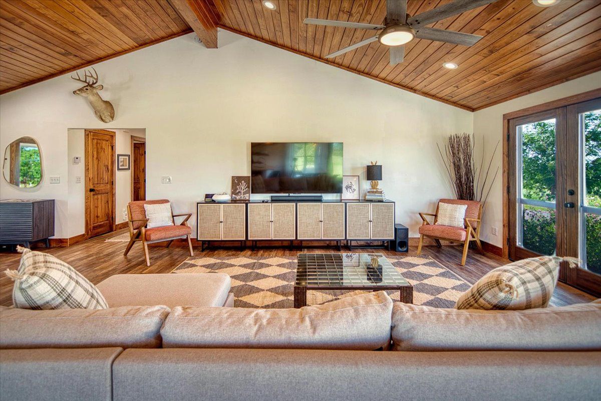 19811 West Ranch Road 152 Llano, TX 78643 - Photo 26 of 38 a living room with furniture and a flat screen tv