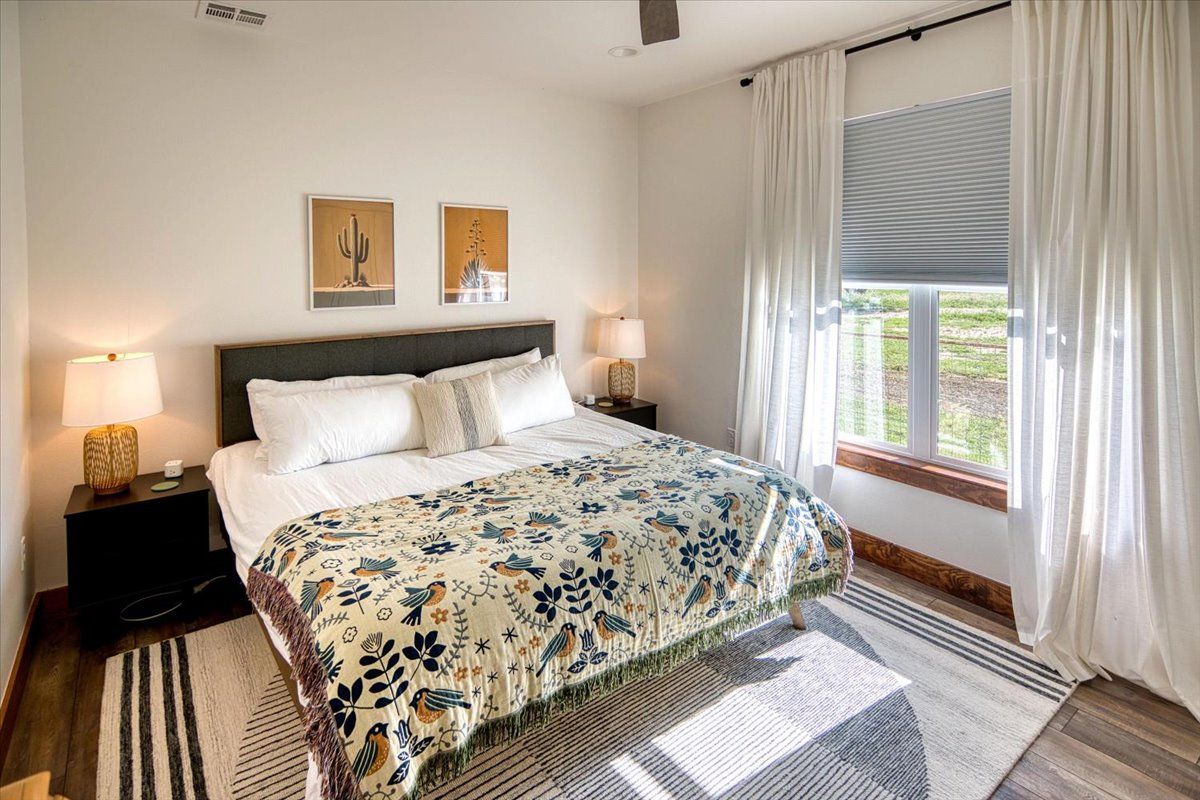 19811 West Ranch Road 152 Llano, TX 78643 - Photo 30 of 38 a bedroom with a large bed and a large window