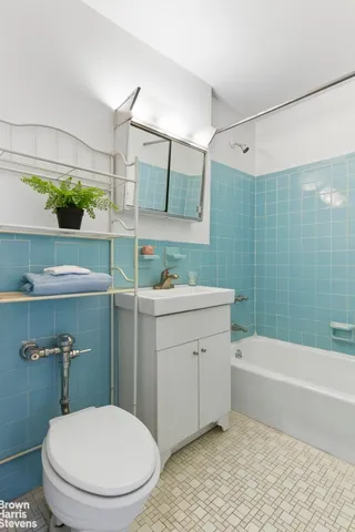 a bathroom with a sink a toilet a mirror and shower