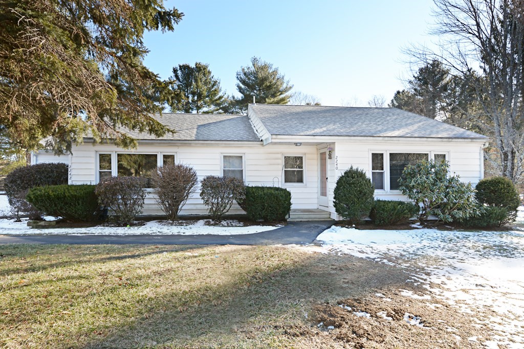 a view of a house with snow on the background