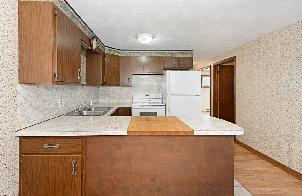 2240-2242 Barre Road Hardwick, MA 01031 - Photo 18 of 31 a kitchen with a refrigerator sink and cabinets