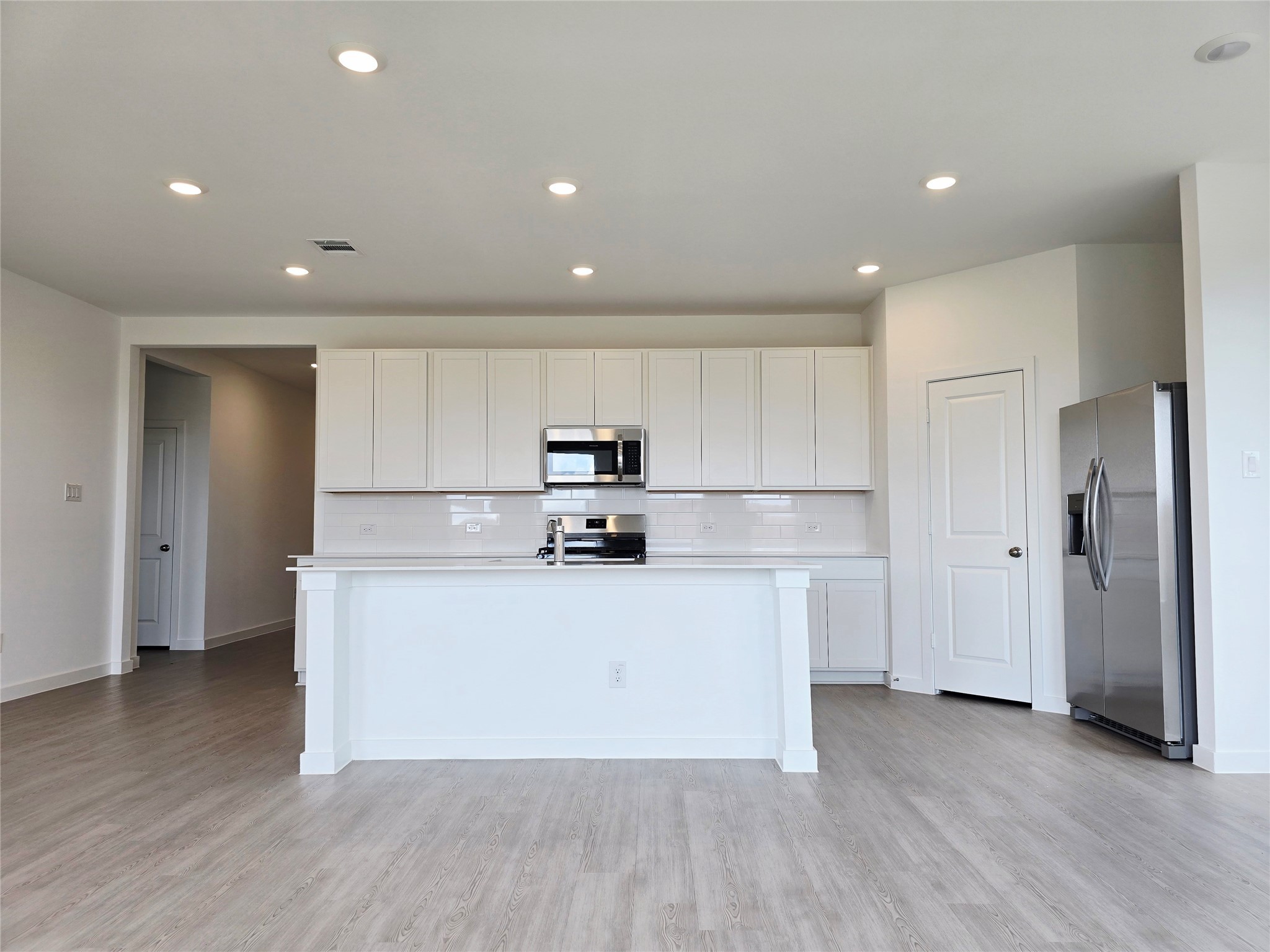 3112 Ruby Ridge Drive Katy, TX 77493 - Photo 22 of 24 a kitchen with stainless steel appliances granite countertop a white refrigerator a sink and white cabinets