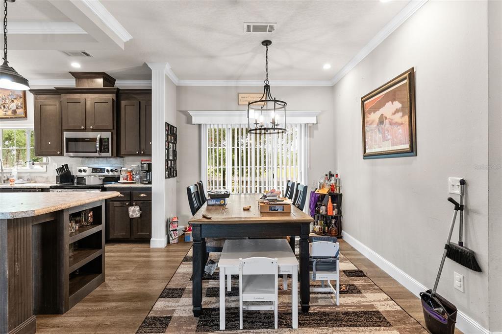 8010 Palmer Road Bartow, FL 33830 - Photo 11 of 22 a view of a dining room with furniture window and wooden floor