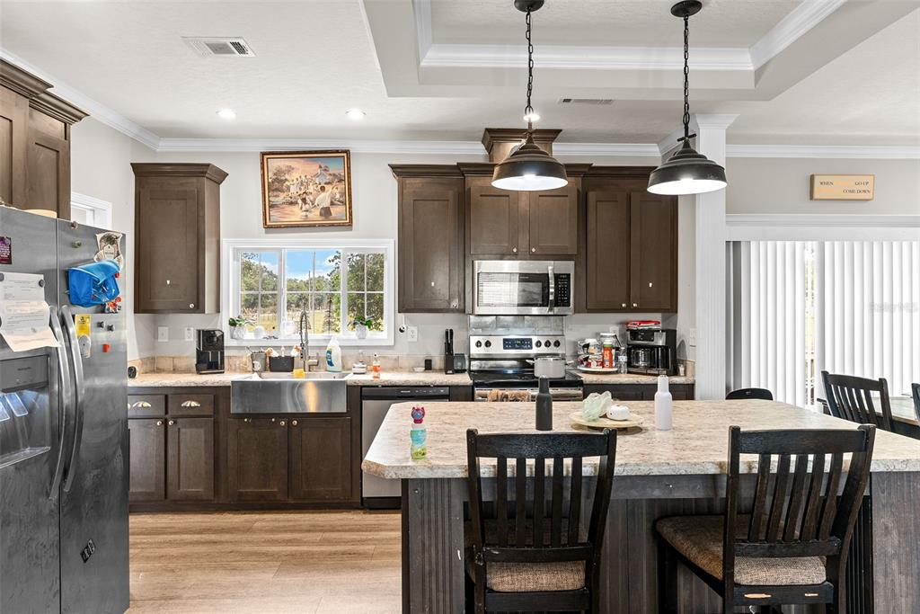8010 Palmer Road Bartow, FL 33830 - Photo 9 of 22 a kitchen with a stove a sink a dining table and chairs