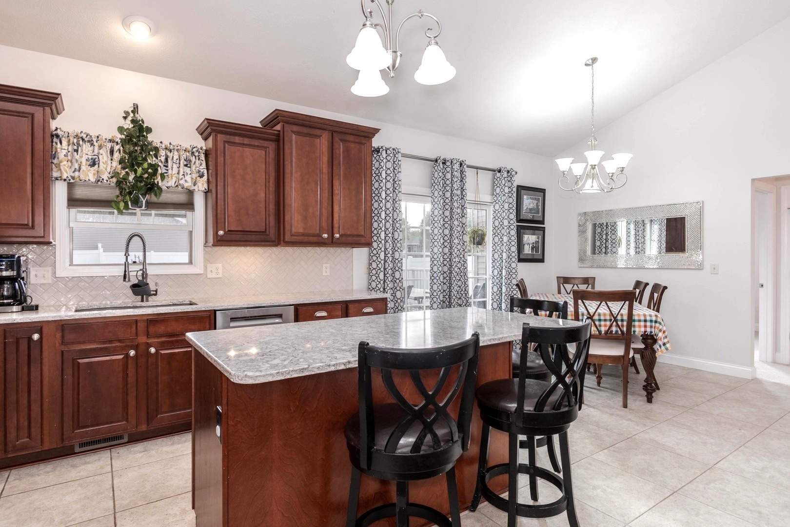 36 Lone Oak Court Bloomington, IL 61705 - Photo 17 of 63 a kitchen with a dining table chairs sink and cabinets