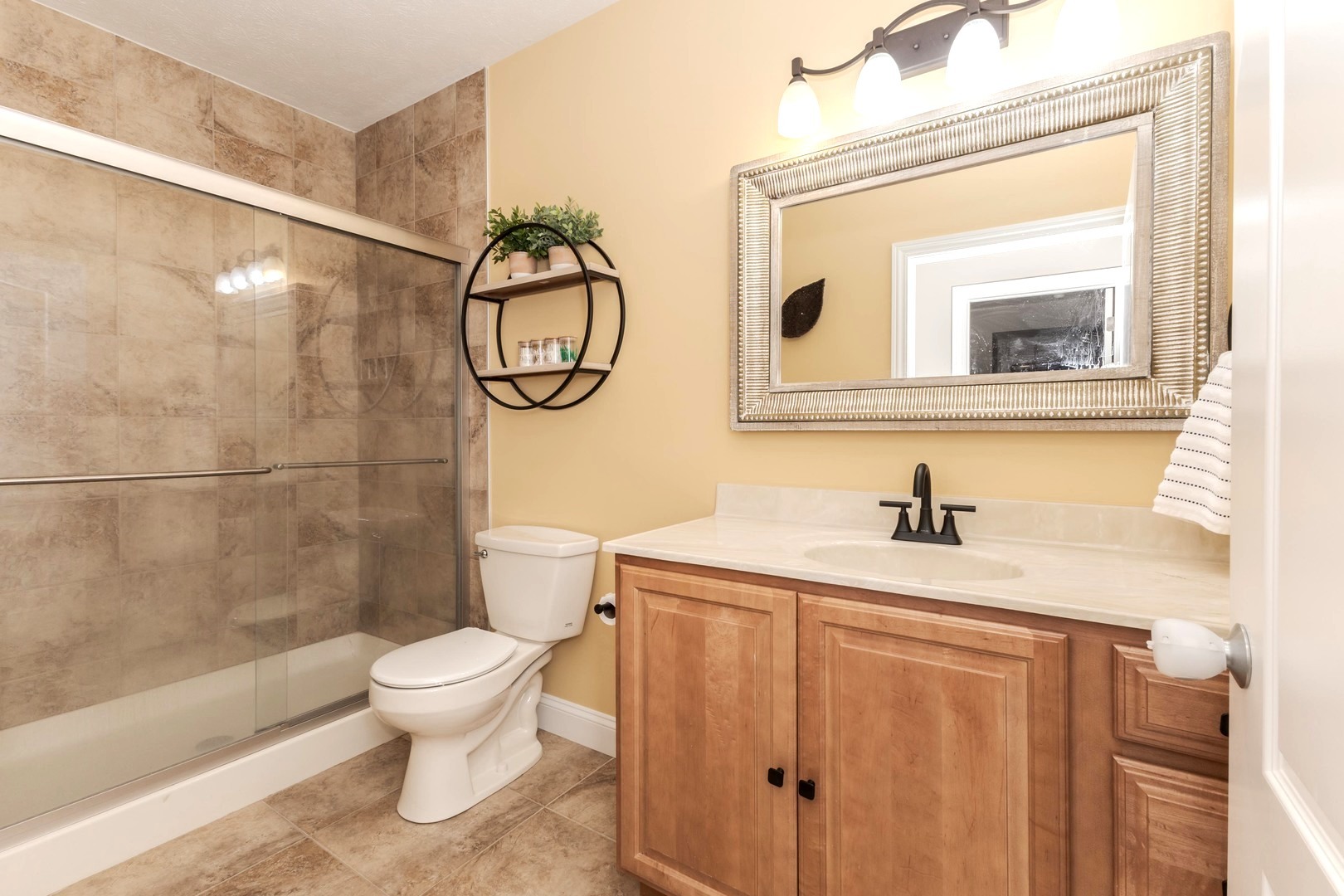 36 Lone Oak Court Bloomington, IL 61705 - Photo 44 of 63 a bathroom with a granite countertop sink toilet a mirror and shower