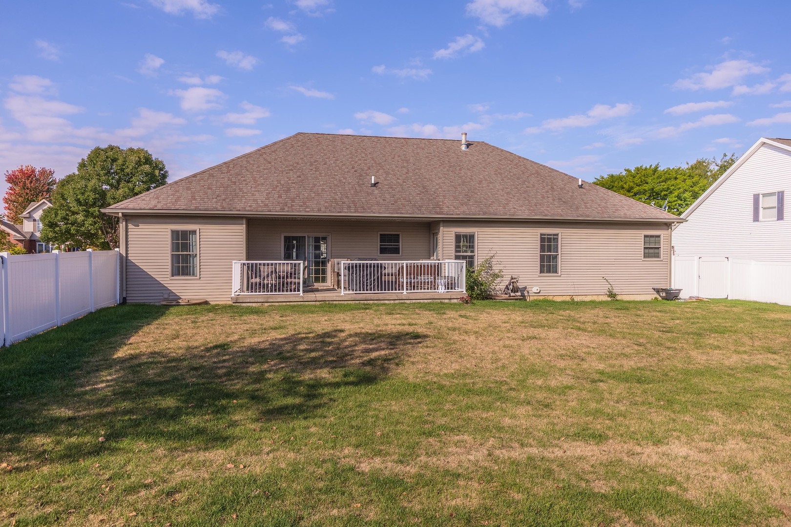 36 Lone Oak Court Bloomington, IL 61705 - Photo 48 of 63 a backyard of a house with table and chairs under an umbrella