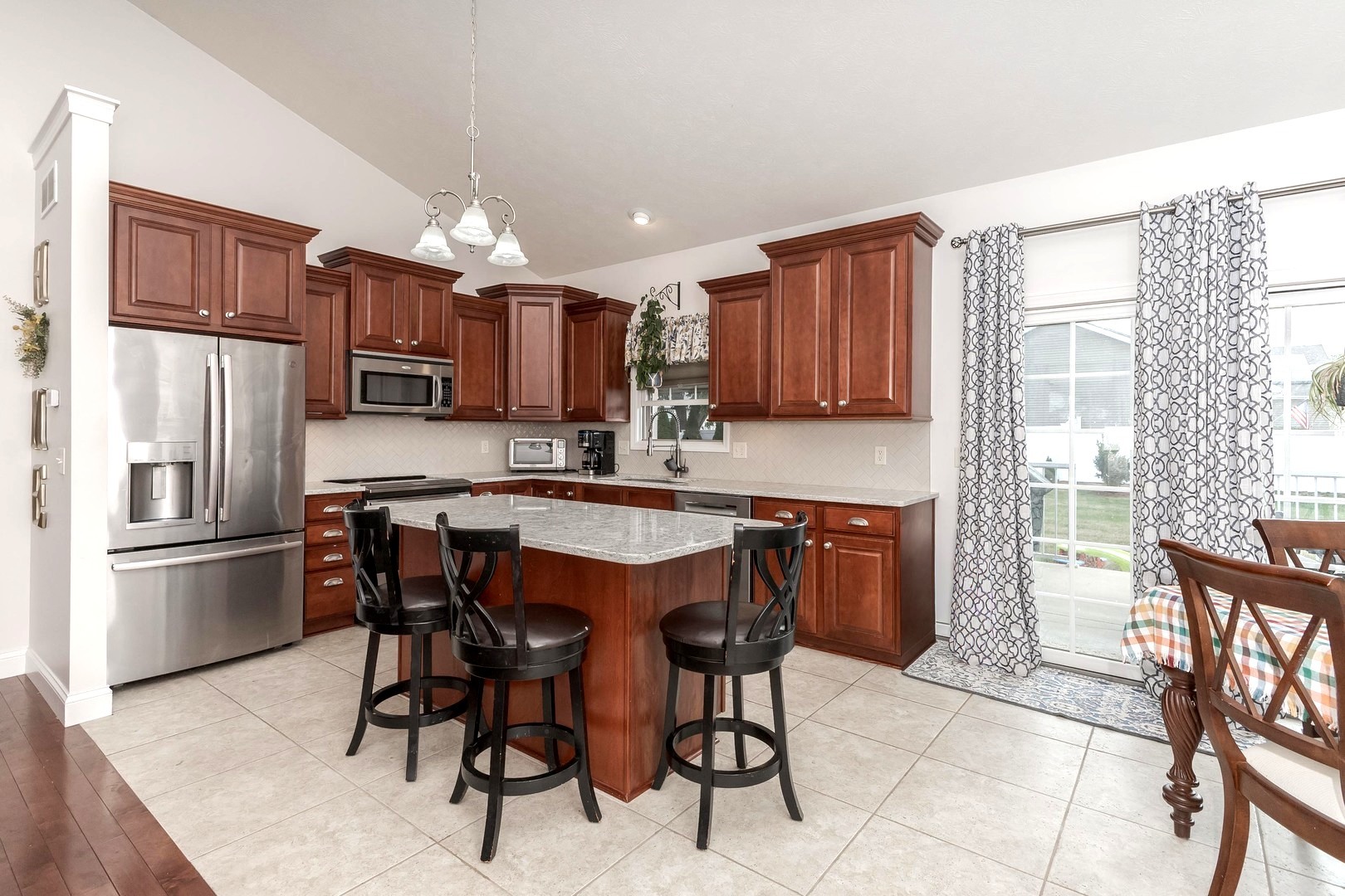 36 Lone Oak Court Bloomington, IL 61705 - Photo 10 of 63 a kitchen with stainless steel appliances granite countertop wooden cabinets a refrigerator a stove a sink and a microwave