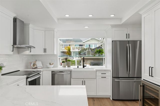 a kitchen with stainless steel appliances a refrigerator sink and cabinets