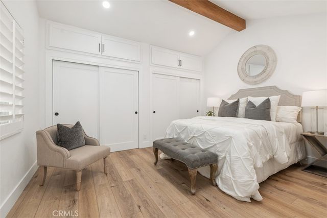 a bed room with a bed and a chair