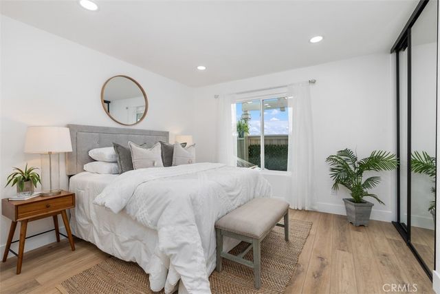 a bedroom with bed and a potted plant