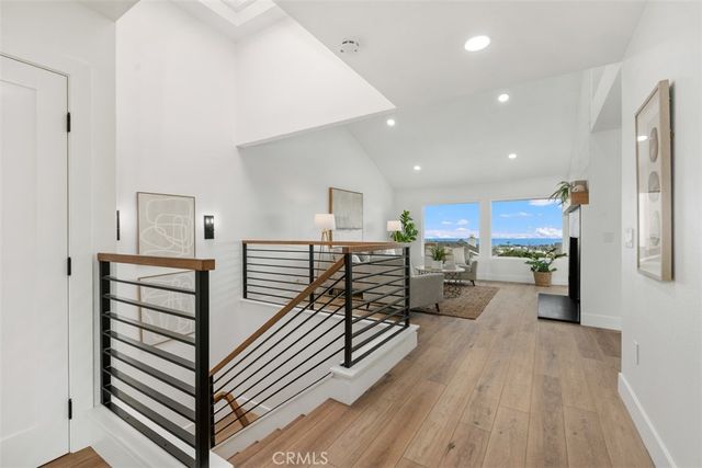 a view of a living room hardwood floor and a kitchen