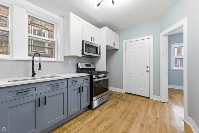 a kitchen with stainless steel appliances granite countertop a stove and a refrigerator