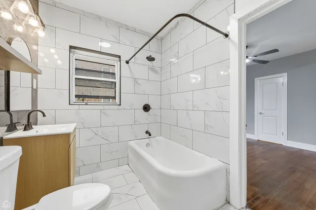 an empty room with a window and a ceiling fan