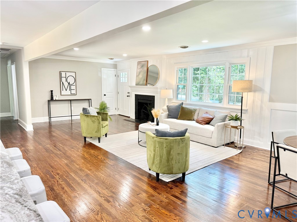7335 Cherokee Road Richmond, VA 23225 - Photo 2 of 30 a living room with furniture a fireplace and a table