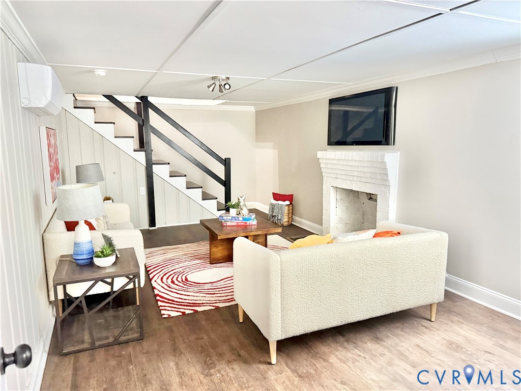 7335 Cherokee Road Richmond, VA 23225 - Photo 25 of 30 a living room with furniture a fireplace and a flat screen tv