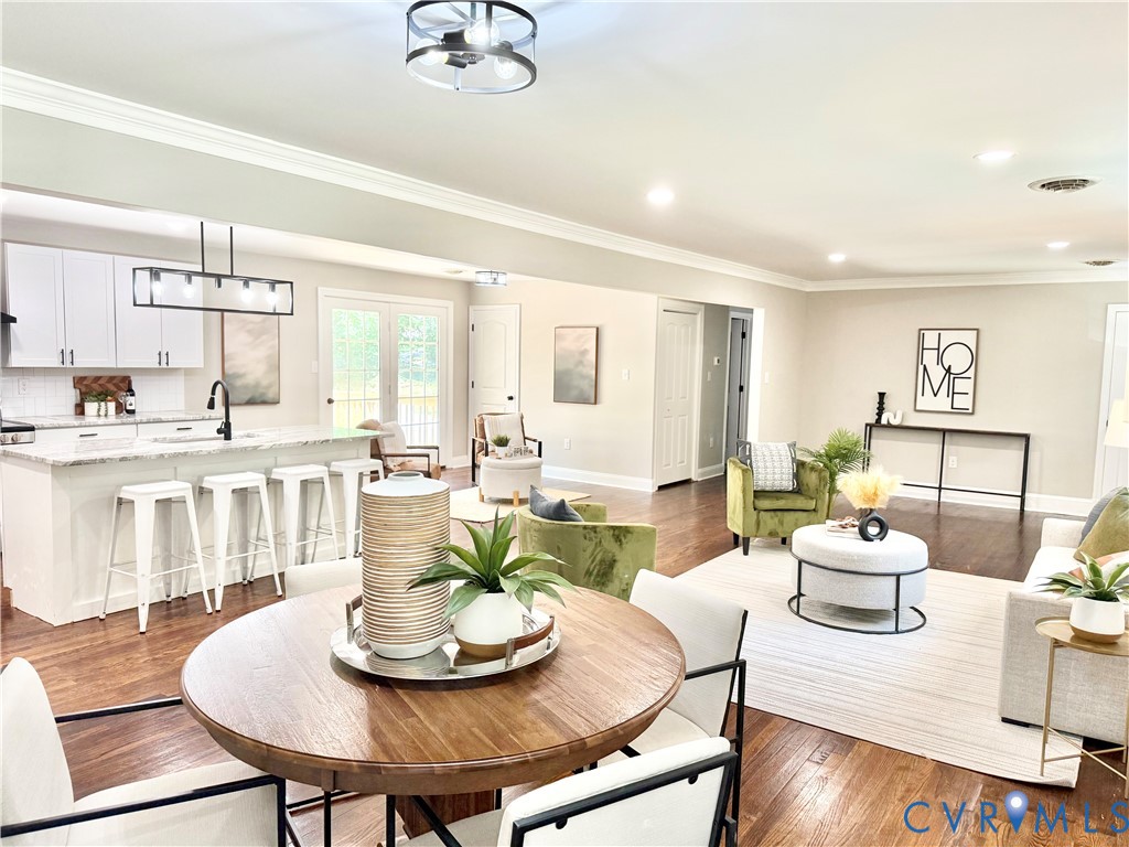 7335 Cherokee Road Richmond, VA 23225 - Photo 5 of 30 a living room with furniture and a dining table