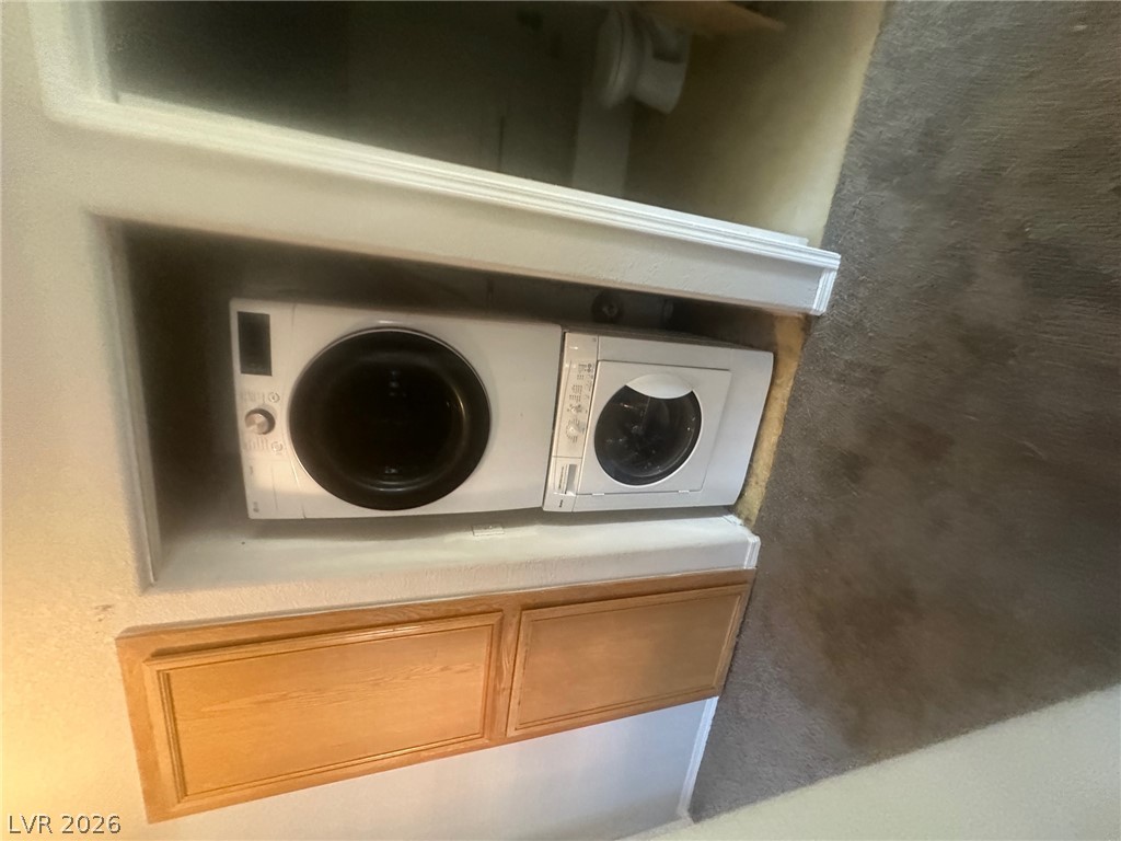 4730 East Craig Road, Unit 1073 Las Vegas, NV 89115 - Photo 9 of 18 A dedicated laundry nook provides practical home convenience next to carpeted living areas.