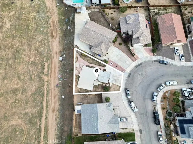 an aerial view of a residential apartment building with a yard