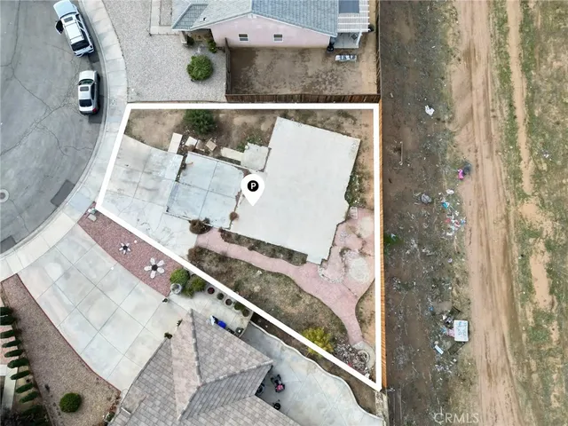 an aerial view of a residential houses with outdoor space