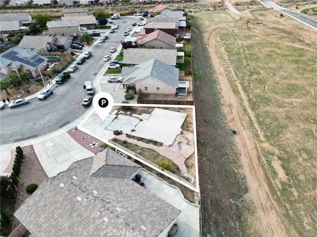 an aerial view of a house with a yard and sitting space