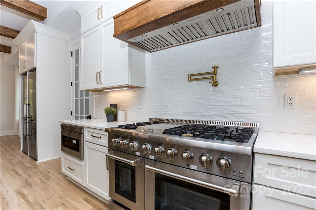 7209 Ramsgate Road Charlotte, NC 28270 - Photo 11 of 41 a kitchen with stainless steel appliances granite countertop a stove a sink dishwasher and refrigerator with wooden floor