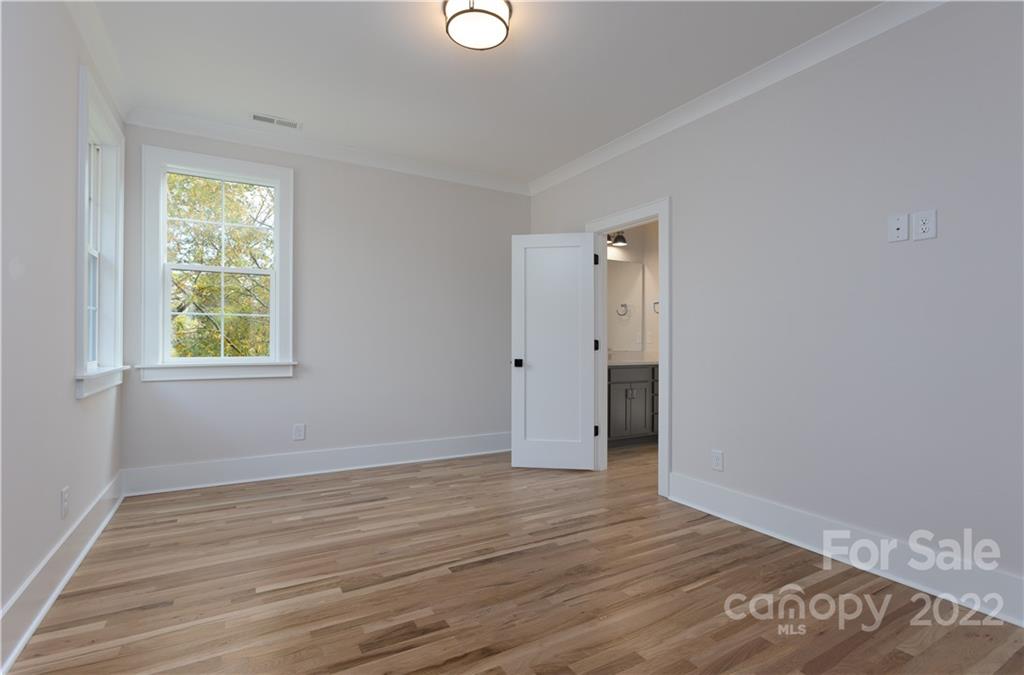 7209 Ramsgate Road Charlotte, NC 28270 - Photo 35 of 41 an empty room with wooden floor and windows