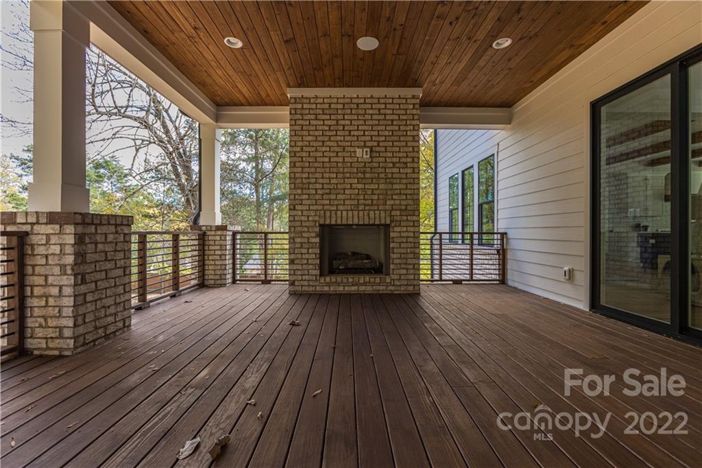 7209 Ramsgate Road Charlotte, NC 28270 - Photo 39 of 41 a view of empty room with wooden floor and fireplace