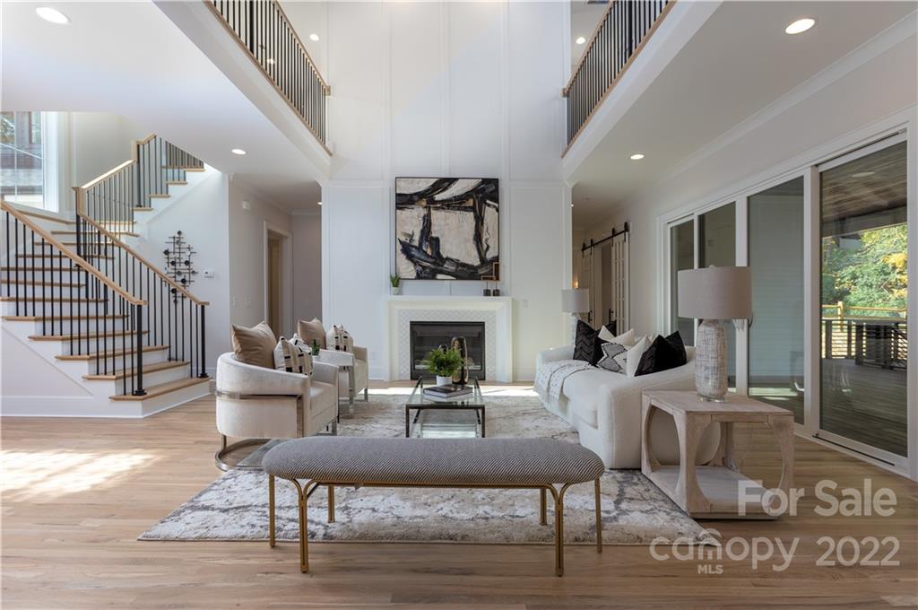 7209 Ramsgate Road Charlotte, NC 28270 - Photo 6 of 41 a living room with furniture a fireplace and a dining table with wooden floor