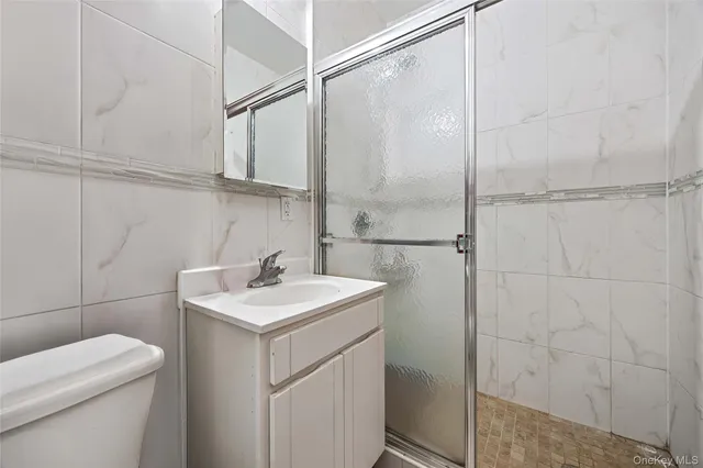 a bathroom with a sink toilet vanity and shower