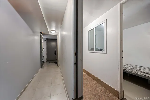 a view of a hallway with a bedroom and bathroom