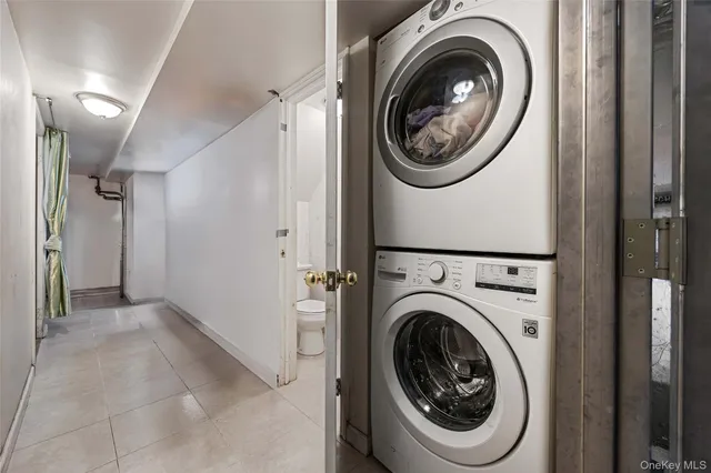 a view of a storage and utility room with washer and dryer